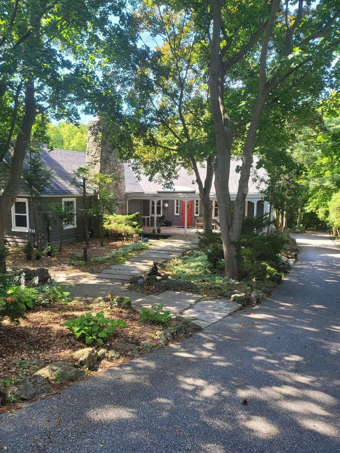 The frontage of the Aspenwood house, framed by mature trees