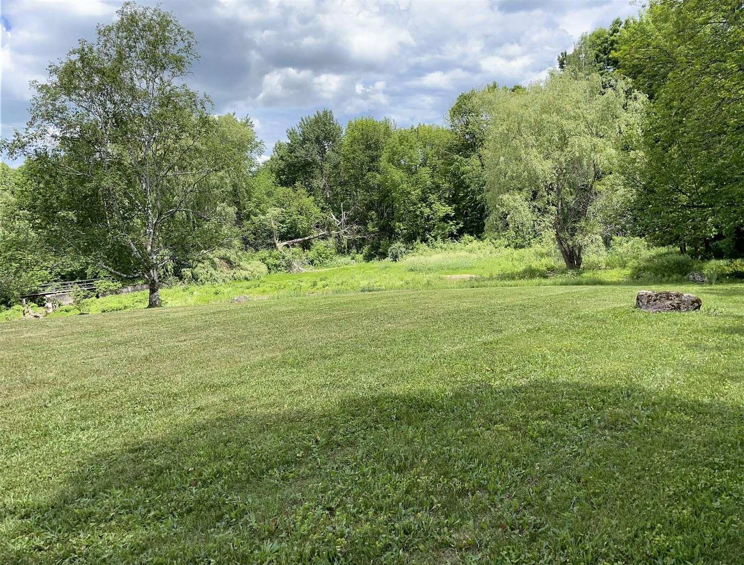 Open meadow and treeline at the country sanctuary